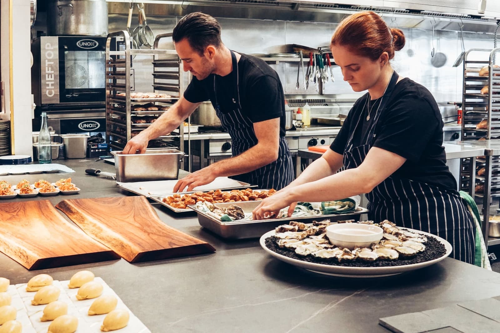 Two cooks working a busy restaurant prep line