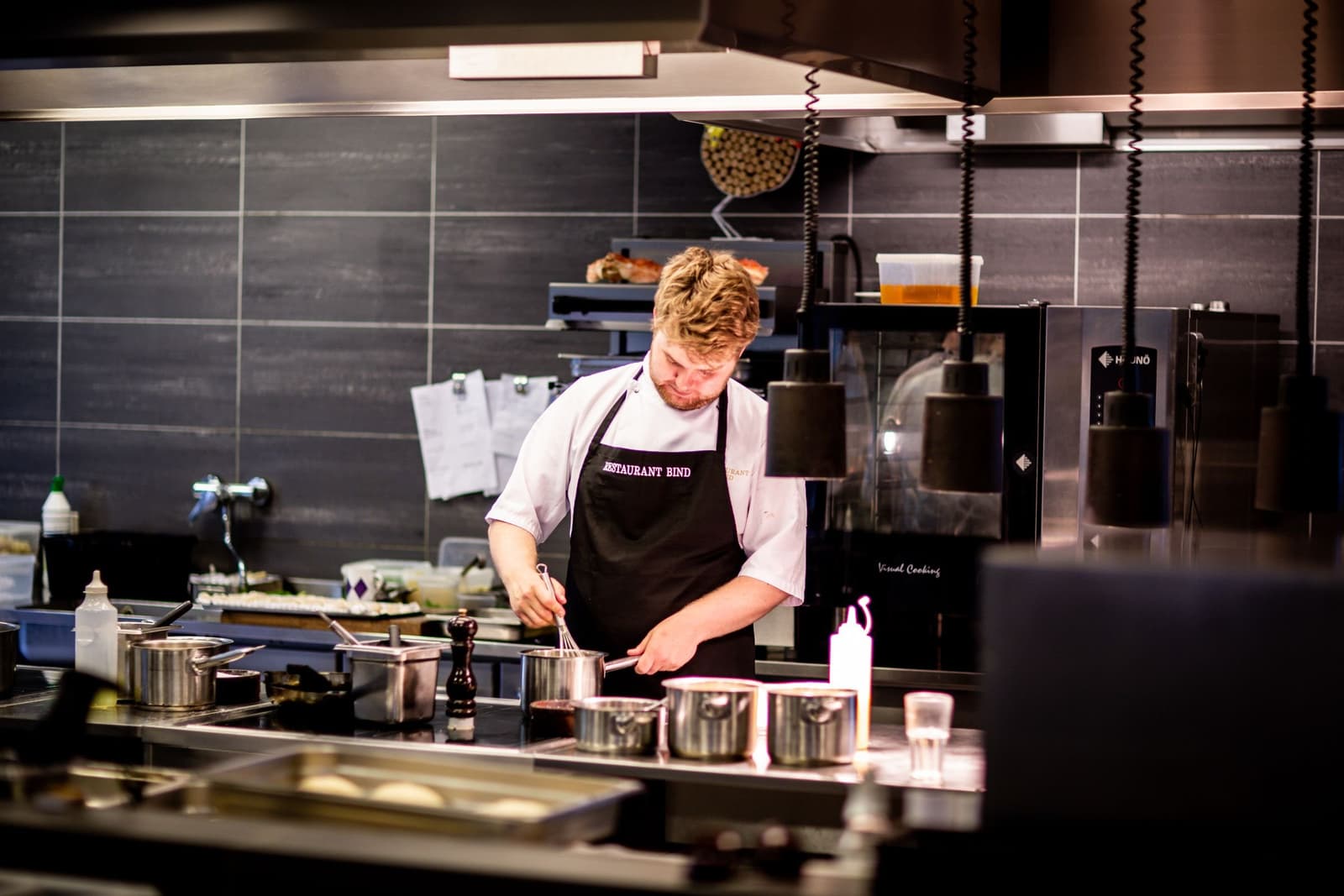 A chef working the pass in a restaurant kitchen